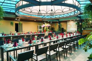 a long table with red figurines on it in a building at Oscar Saigon Hotel in Ho Chi Minh City +74 photos