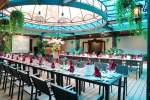 a long dining room with tables and chairs at Oscar Saigon Hotel in Ho Chi Minh City