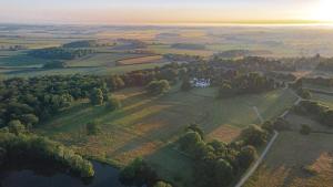 eine Luftaufnahme eines Hauses auf einem Hügel neben einem See in der Unterkunft The Flat - Waresley Park Estate 
