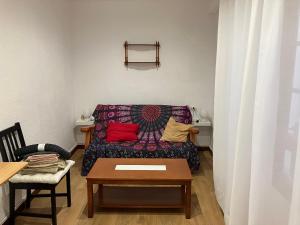 a living room with a couch and a table at El COTO - VUT 6639 AS in Gijón