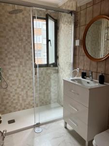 a bathroom with a shower and a sink and a mirror at El COTO - VUT 6639 AS in Gijón