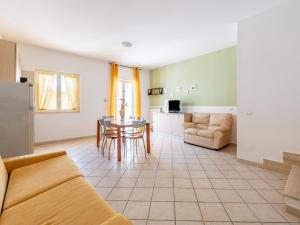 a living room with a couch and a table at Belvilla by OYO Conca degli Dei con giardino in Paestum