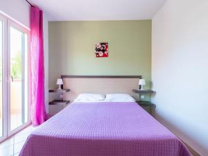 a bedroom with a large bed with a purple blanket at Belvilla by OYO Conca degli Dei con giardino in Paestum +13 photos