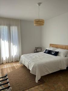 a bedroom with a large bed with white sheets at Villa Ragona Taormina in Taormina