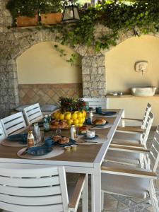 a table with food and fruit on top of it at Villa Ragona Taormina in Taormina