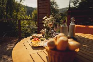 a wooden table with food on it on a deck at Glamp Ellsa in Mikulov v Krušných Horách