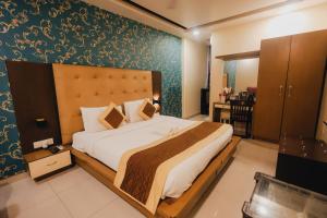 a bedroom with a large bed in a room at HOTEL SURYA INTERNATIONAL in New Delhi