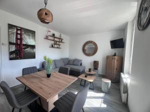 a living room with a table and a couch at Vue imprenable in Nemours