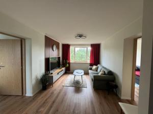a living room with a couch and a tv at Modern apartment in Rõuge in Rõuge