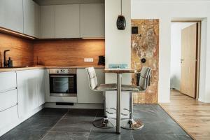 a kitchen with a counter and two bar stools at Modern apartment in Rõuge in Rõuge