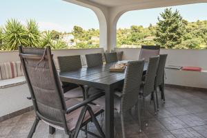 a dining room with a table and chairs at Apartments Marijin Dvor in Splitska +17 photos