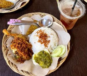a plate of food with rice and vegetables on a table at Homestay Syariah Melati Borobudur in Borobudur