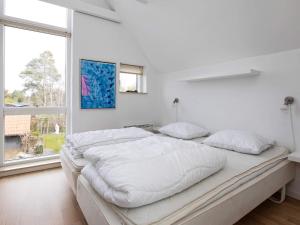 a white bedroom with a large bed and a window at 6 person holiday home in Væggerløse-By Traum in Marielyst