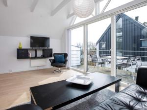 a living room with a couch and a table at 6 person holiday home in Væggerløse-By Traum in Marielyst +23 photos