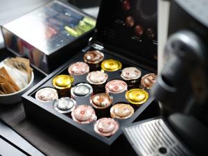 a box of donuts sitting on top of a table at Hotel Xenia, Autograph Collection in London
