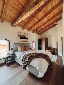 a bedroom with a large bed and a wooden ceiling at Paraje de Montaña de Ensueño en el Corazón de Camprodon in Camprodon