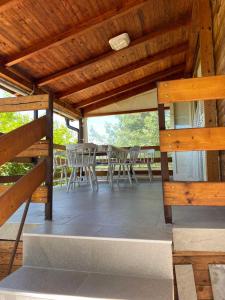 a patio with chairs and a table on a deck at HELONA in Arandjelovac