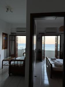 a bedroom with two beds and a view of the ocean at Beach House Antonis Avlakia in Avlákia +11 photos