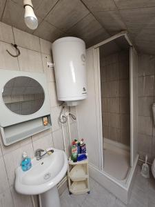 a small bathroom with a sink and a shower at Old Bazaar Altunalem Stay in Novi Pazar +18 photos