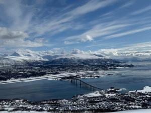 an aerial view of a city with snow covered mountains at Apartment in Tromsø in Tromsø