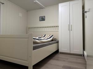 a bedroom with a bed and a closet at Apartment in Tromsø in Tromsø