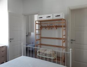 a bedroom with a crib and a towel rack at SanMarco54 in Cesena