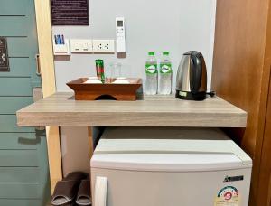a table on top of a toilet in a bathroom at Best LD Hotel โรงแรมเบส แอลดี in Hua Hin