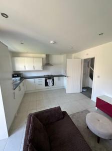 a living room with a couch and a table at New 4-Bedroom Family Home with Free Parking in Bredbury