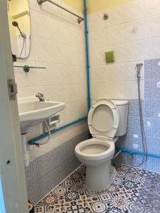 a bathroom with a toilet and a sink at Haiya Guesthouse room 9 in Chiang Mai
