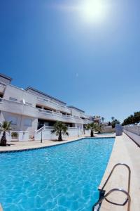 a swimming pool in front of a building at Be Free Laguna Playa in Roquetas de Mar