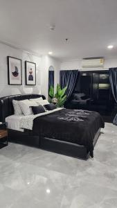 a bedroom with a large bed in a room at Patong Tower 2 Bedroom Sea View in Patong Beach