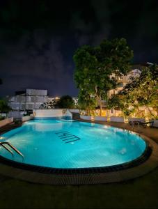 a large blue swimming pool at night at Patong Tower 2 Bedroom Sea View in Patong Beach