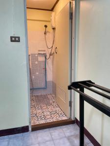 a bathroom with a shower with a tile floor at Haiya Guesthouse room 9 in Chiang Mai +4 photos