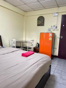 a bedroom with a bed and a table with a red towel at Haiya Guesthouse room 9 in Chiang Mai