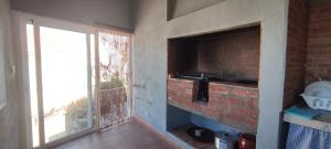 a kitchen with a brick wall and a window at "VILLA SERVANDA" - Casa Canaria construida a PRINCIPIOS DEL SIGLO XIX in Puntagorda