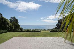 a view of a park with a field of grass at Bungalow Coastal Retreat and Terrace Studios in Tataraimaka