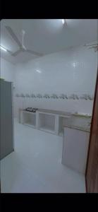 a white room with a table and a refrigerator at صلالة in Salalah