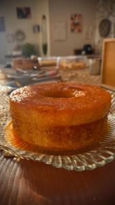 a cake sitting on a glass plate on a table at Oka Pousada Atins in Atins