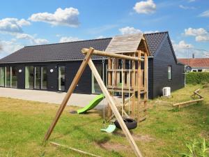 a playground in front of a house at 14 person holiday home in Hadsund in Hadsund