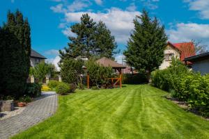 a yard with green grass and trees at Andrejkin dom in Blatnica