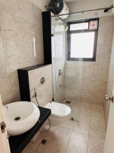 a bathroom with a sink and a toilet and a shower at Joy Pvt 1Bhk in Amanora Most Awarded Township in Pune