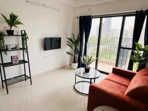 a living room with a couch and a table with plants at Joy Pvt 1Bhk in Amanora Most Awarded Township in Pune