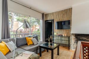 a living room with a couch and a fireplace at Canela Homes COSTA CA NOSTRA in Gavà