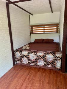 a large bed in a room with a wooden floor at Sobral Rice Terraces View in Antihon