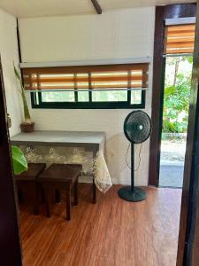 a room with a fan and a table and a window at Sobral Rice Terraces View in Antihon