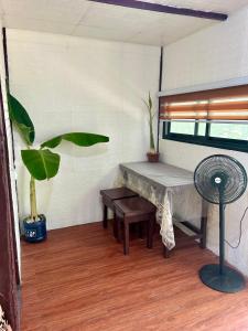 a room with a bench and a fan and a window at Sobral Rice Terraces View in Antihon