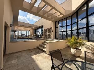 a large room with a table and chairs and windows at Hotel Ninety Alameda Lorena São Paulo in Sao Paulo