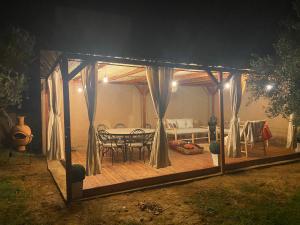 a gazebo with a table and chairs on a deck at Villa Dar Daraa with Pool in Najem