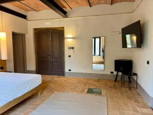 a bedroom with a bed and a flat screen tv at The Monteleone Umbria Retreat in Monteleone dʼOrvieto +146 photos
