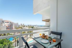 a table with a plate of food on a balcony at Costa Serena Apartment 420 in Costa de Adeje